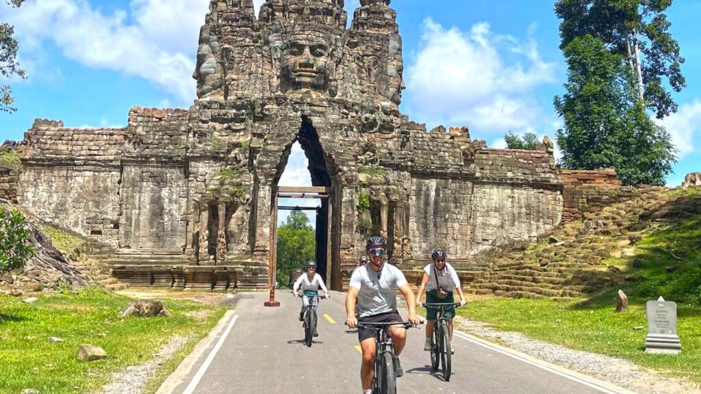 Cycling through the south gate of Angkor Thom with family tour, Bike of the Angkor Temple & History Tour with Lunch