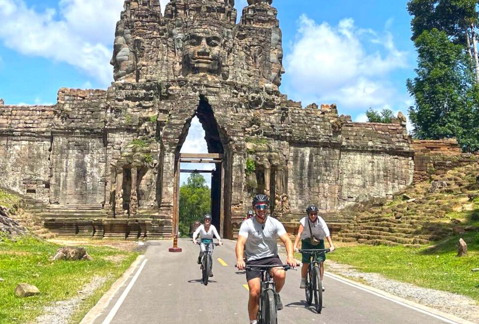 Cycling through the south gate of Angkor Thom with family tour, Bike of the Angkor Temple & History Tour with Lunch