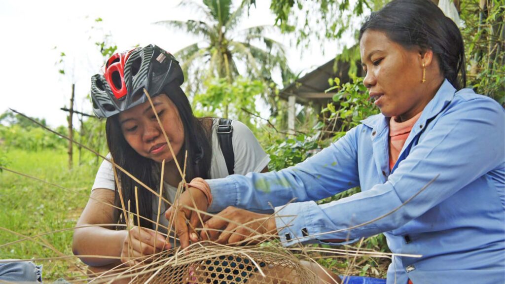 Local villager weaving the bucket of rattan tree