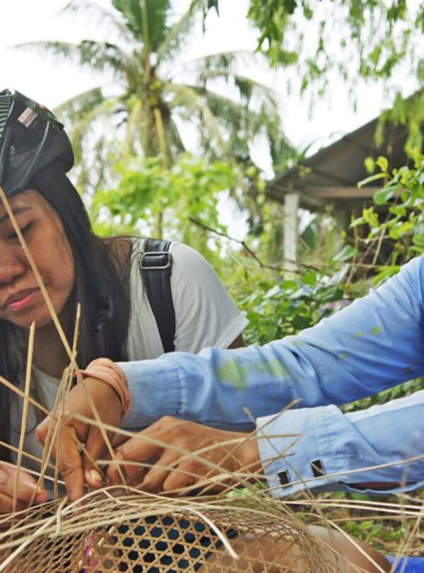 Local villager weaving the bucket of rattan tree