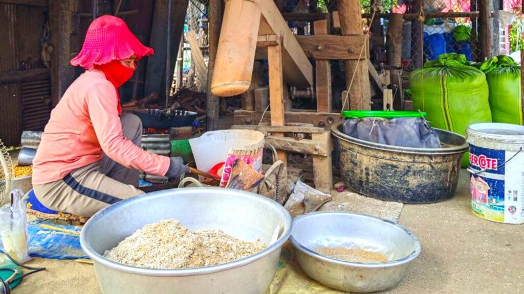 Local people process the rice for cooking at the rice miller station