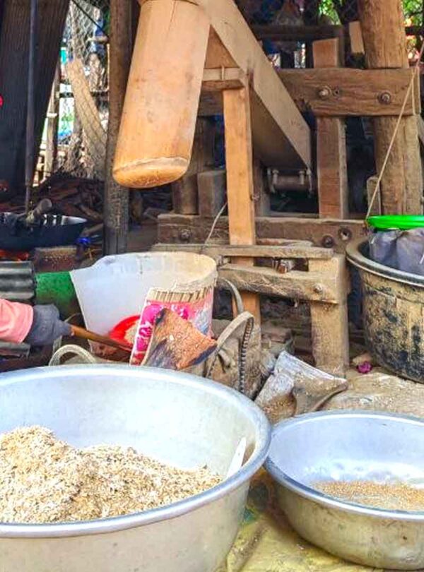 Local people process the rice for cooking at the rice miller station