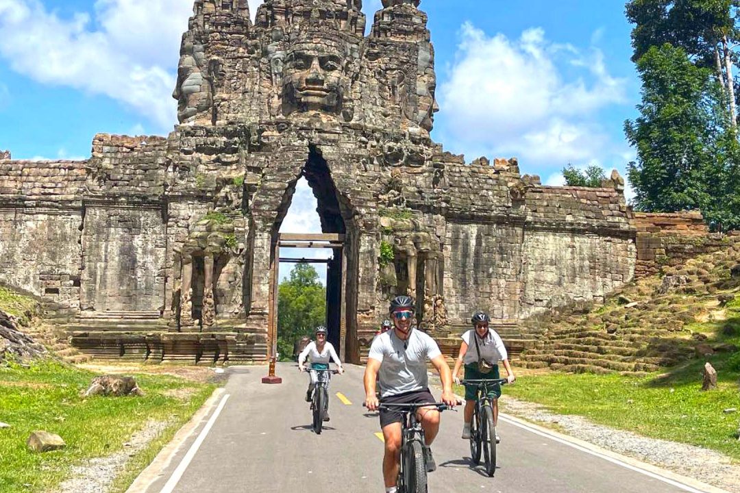Cycling through the south gate of Angkor Thom with family tour, Bike of the Angkor Temple & History Tour with Lunch
